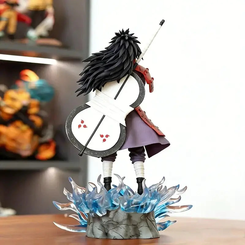 Black-haired naruto uchiha madara pvc statue with white and black cello weapon on translucent blue flame base