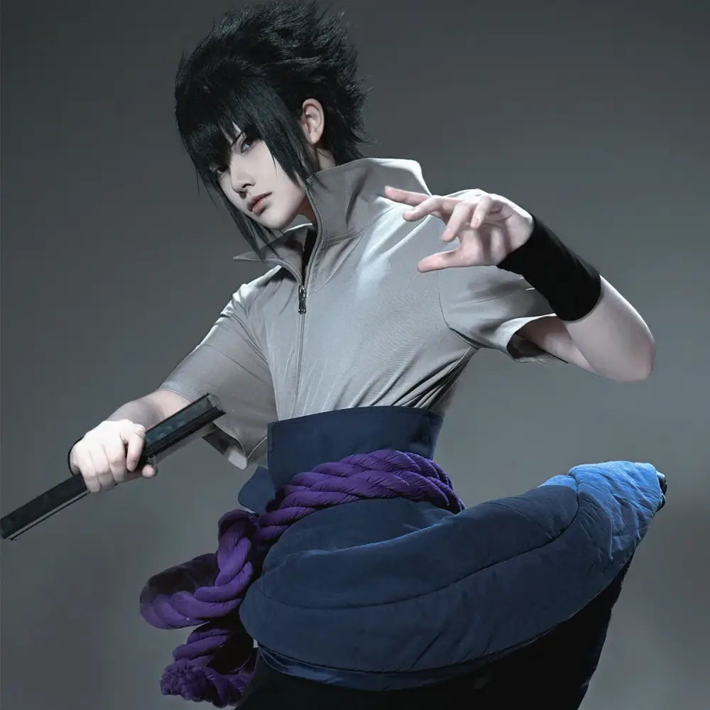 A cosplayer wearing a uchiha sasuke cosplay costume with gray zip-up top, black wristband, and purple rope belt
