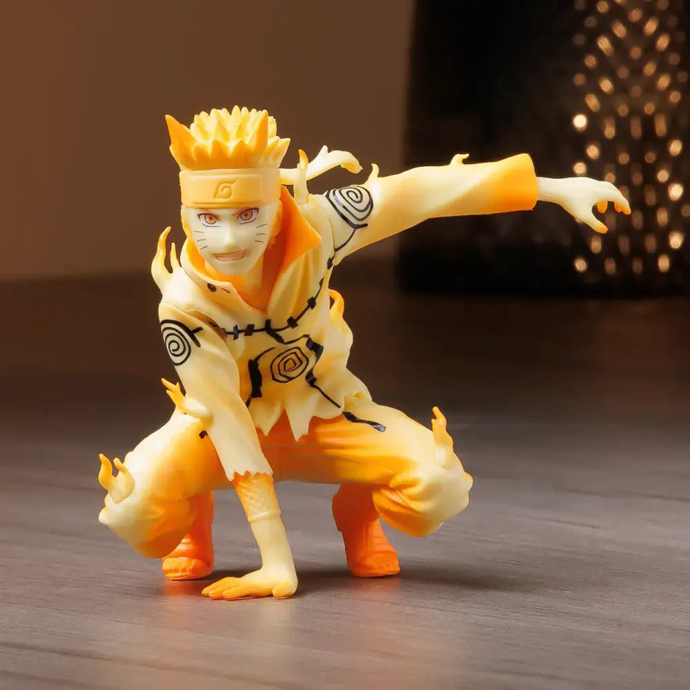 Orange and yellow naruto uzumaki pvc statue in nine-tails chakra mode with spiral arm markings and konoha headband