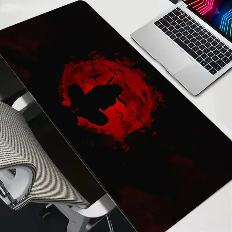 Black gaming mousepad with red circular design featuring silhouetted bats and an anime figure from demon slayer series