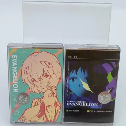Two clear plastic cassette tapes featuring teal and orange asuka langley soryu anime artwork from neon genesis evangelion
