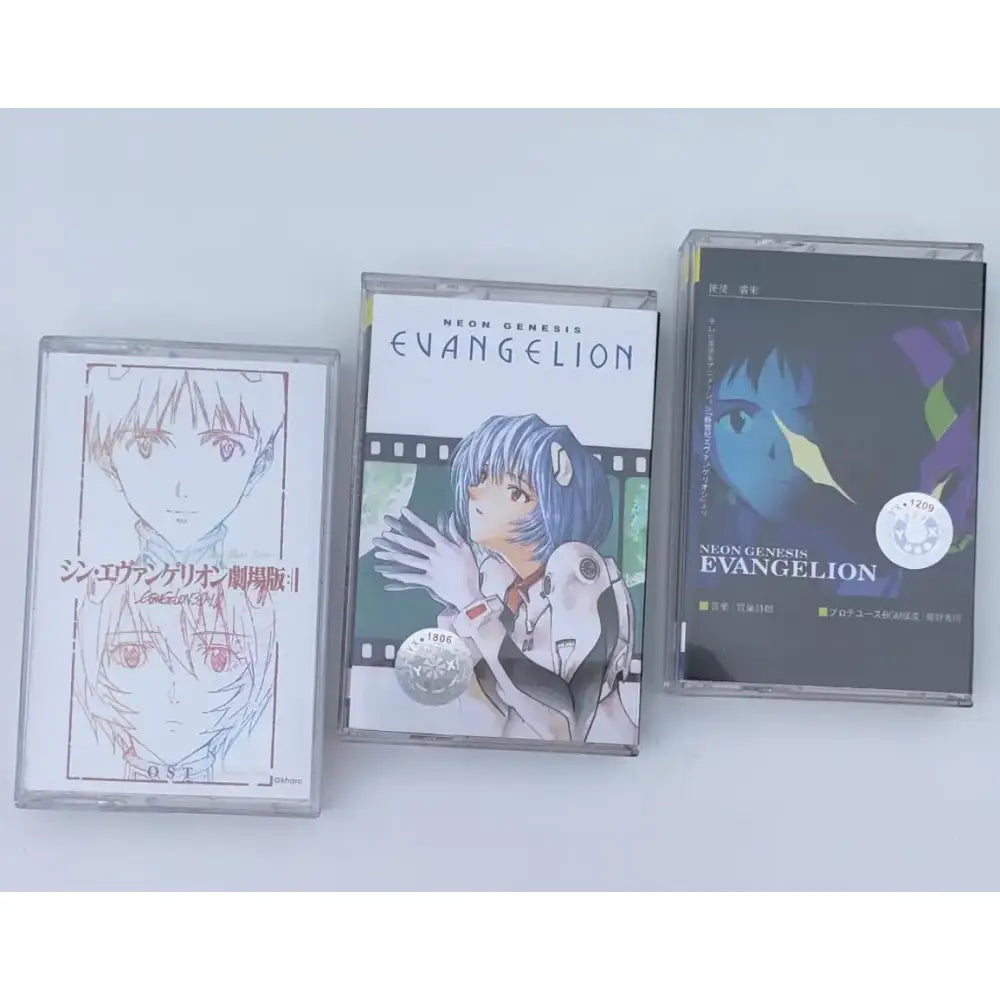 Three neon genesis evangelion asuka langley soryu cassette tapes with distinct artwork in clear plastic cases for soundtrack use