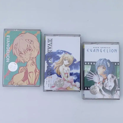 Three evangelion-themed clear plastic cassette tapes featuring asuka langley soryu anime artwork from one last kiss soundtrack