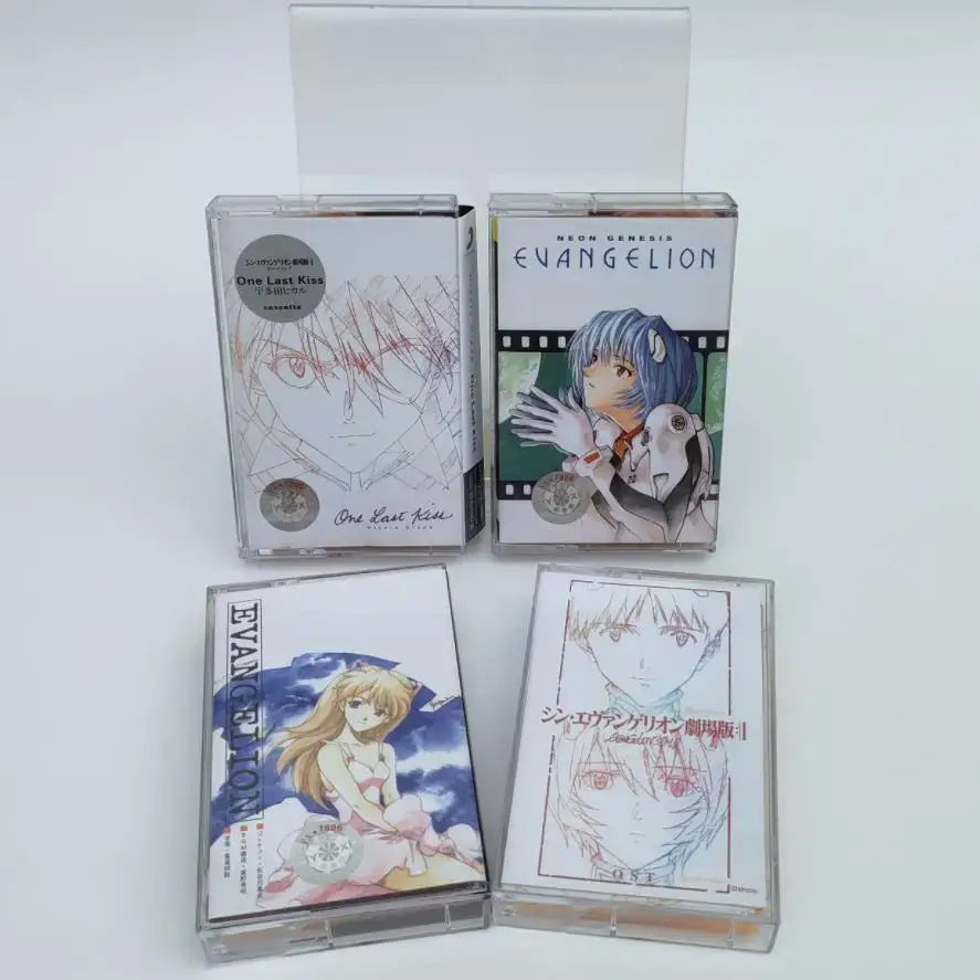 Four clear plastic cassette tapes featuring colorful anime artwork from neon genesis evangelion and one last kiss soundtrack with asuka langley soryu