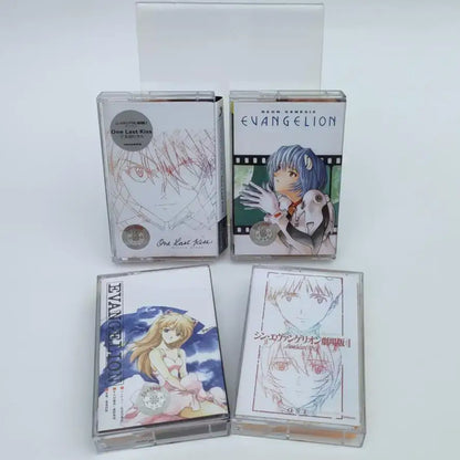 Four clear plastic cassette tapes featuring colorful anime artwork from neon genesis evangelion and one last kiss soundtrack with asuka langley soryu