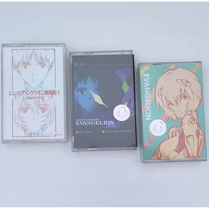 Three anime-themed cassette tapes featuring asuka langley soryu artwork from neon genesis evangelion one last kiss soundtrack