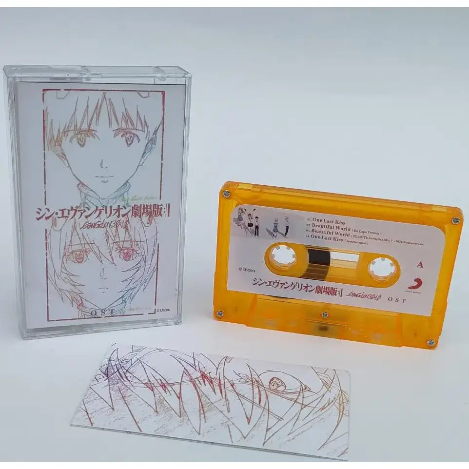 Orange translucent cassette tape with white label featuring anime artwork from neon genesis evangelion asuka langley soryu