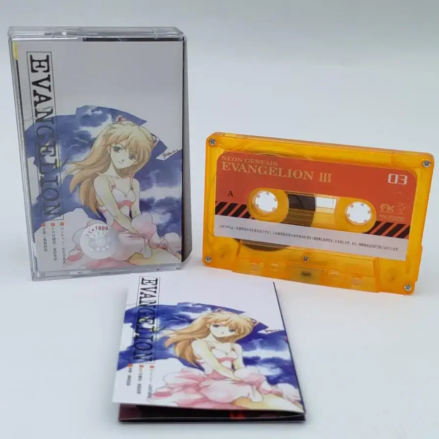 Orange translucent cassette tape with red label and black stripes featuring neon genesis evangelion iii for asuka langley soryu soundtrack