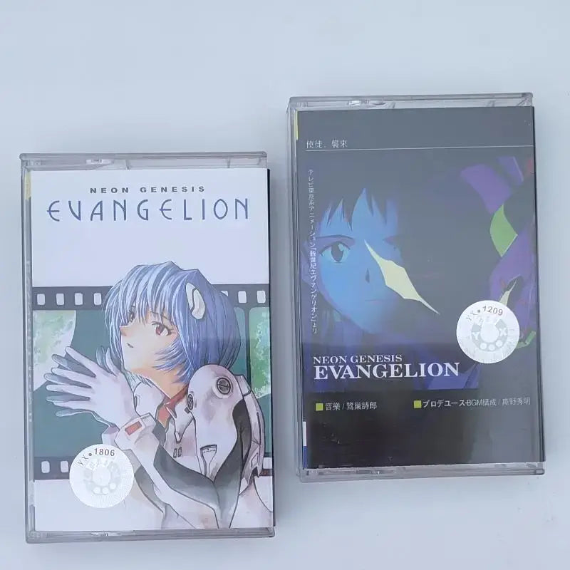 Two clear plastic cassette tapes featuring asuka langley soryu artwork from neon genesis evangelion one last kiss soundtrack
