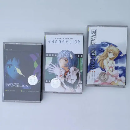 Three clear plastic cassette tapes with neon genesis evangelion asuka langley anime artwork and distinct color designs