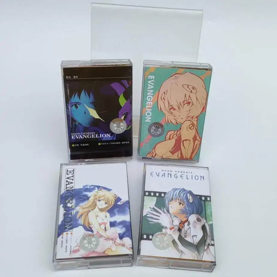 Four transparent plastic cassette tapes with neon genesis evangelion asuka langley anime artwork and distinct colors