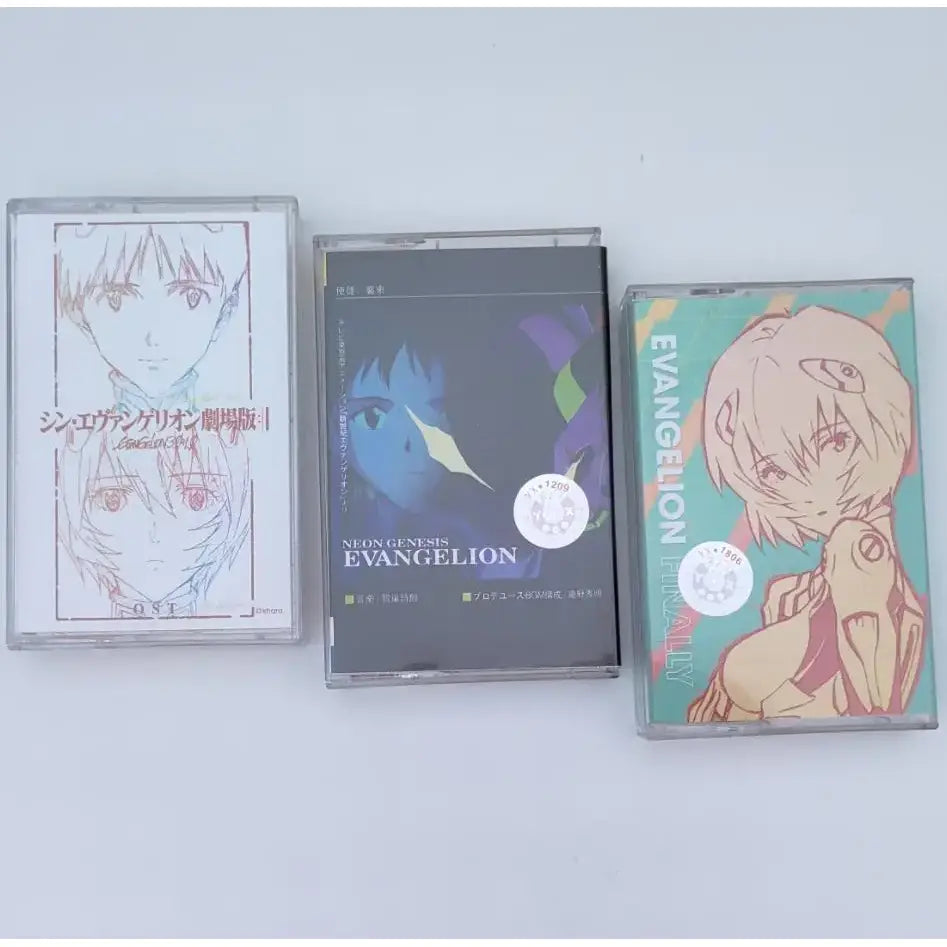 Three anime-themed cassette tapes featuring neon genesis evangelion asuka langley with distinct artwork and colors