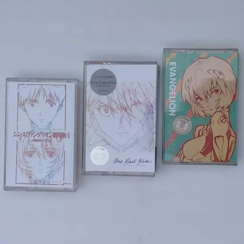 Three neon genesis evangelion anime-themed cassette tapes featuring evangelion asuka langley artwork in vibrant colors