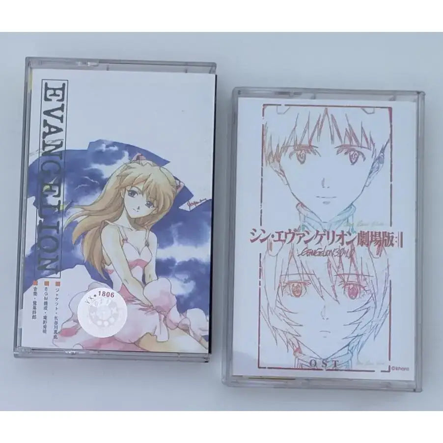 Two clear plastic cassette tapes with neon genesis evangelion asuka artwork featuring blonde and line-drawn characters