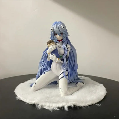 Blue-haired neon genesis evangelion ayanami rei pvc figure in white and black armored suit kneeling on fluffy base