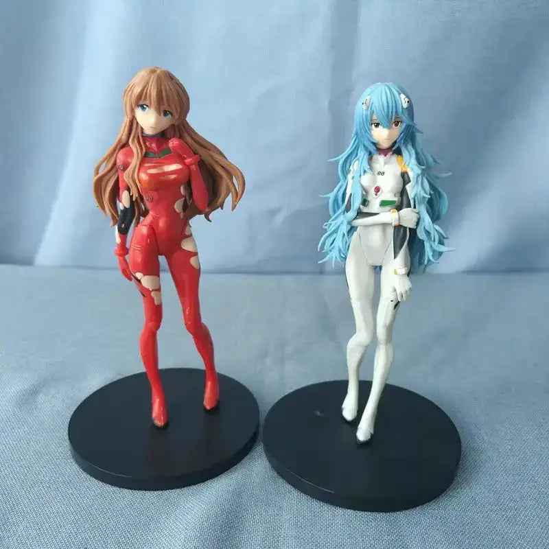 Two detailed neon genesis evangelion pvc figures featuring a red and black suit and a white and green suit with long hair