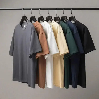 A collection of minimalist oversized cotton crew neck t-shirts in muted tones featuring eva unit 01 design