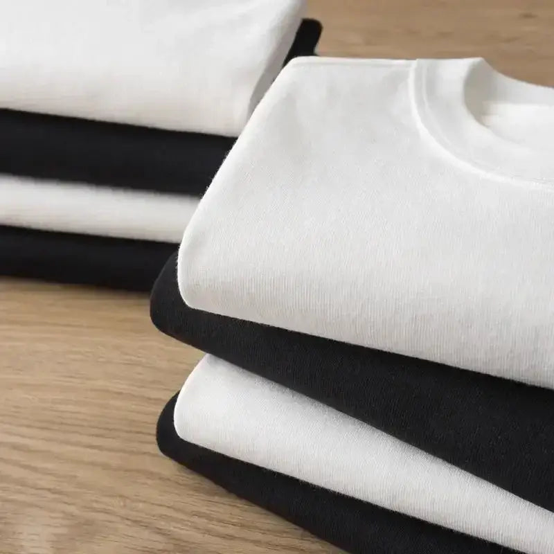 Stack of neatly folded white and black neon genesis evangelion eva unit 01 cotton crew neck t-shirts