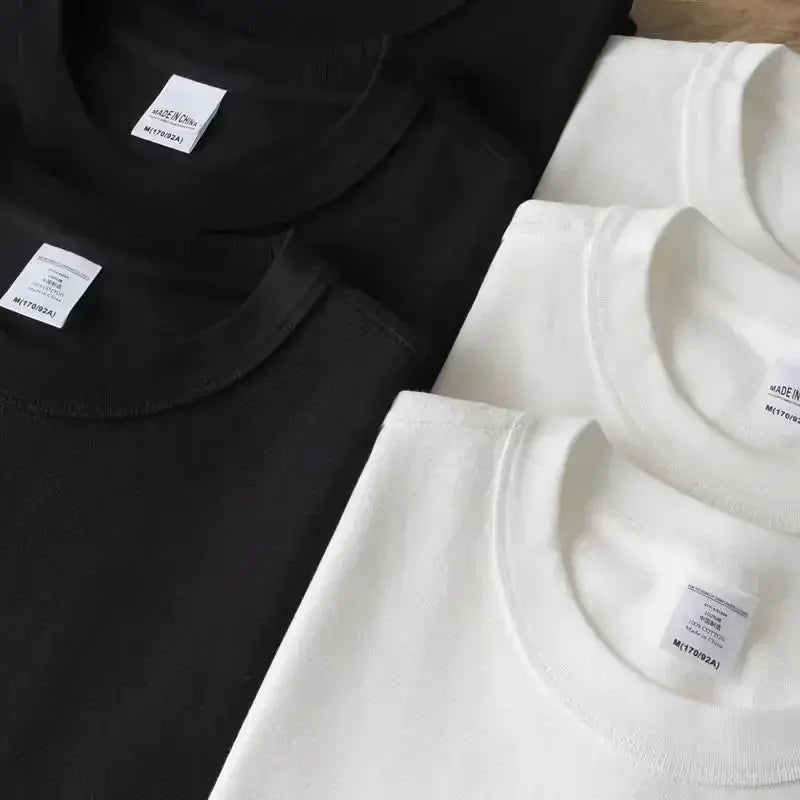 Neatly folded black and white cotton crew neck genesis evangelion eye shirts with minimalist labels