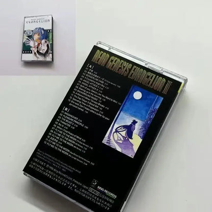 Black rei cassette tape case with gold lettering and blue anime illustration under moonlit sky from neon genesis evangelion soundtrack
