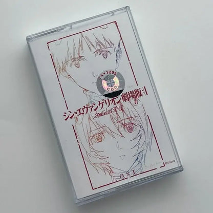 Clear plastic rei cassette tape case from neon genesis evangelion featuring red line anime artwork and silver holographic label