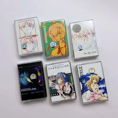 Six clear plastic cassette tapes featuring colorful neon genesis evangelion anime artwork from sagisu shiro ost album