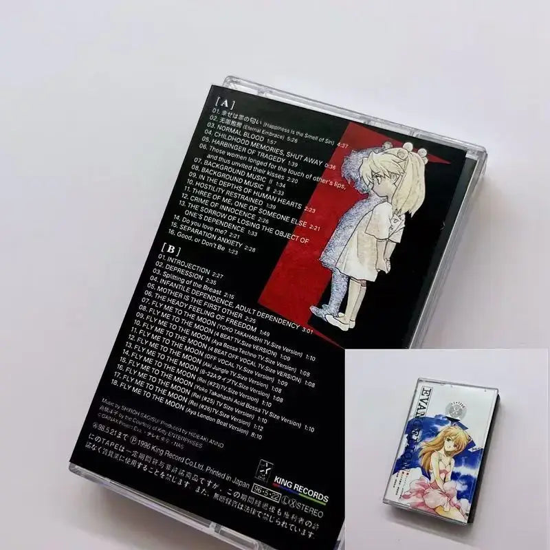 Clear plastic cassette case with neon genesis evangelion anime girl artwork and silver evan audio tape box for ost album