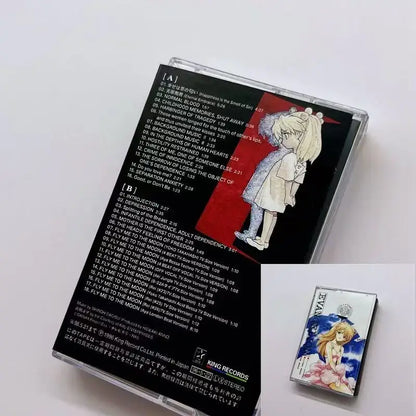 Clear plastic cassette case with neon genesis evangelion anime girl artwork and silver evan audio tape box for ost album