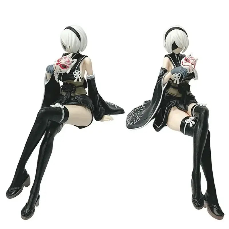 Black and white PVC anime girl figure of 2b from nier automata seated holding her signature mask dynamically