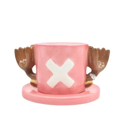 Pink ceramic cup shaped like one piece chopper hat with brown wing handles and white x emblem, no saucer set visible