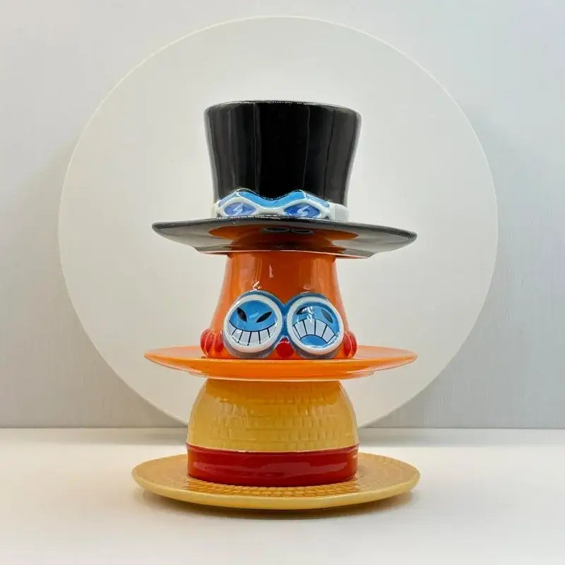 One piece chopper hat-shaped ceramic cup and saucer set with a colorful stacked figurine design and black top hat detail
