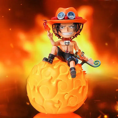 Orange-hatted chibi-style luffy night light figure with black hair and skull necklace on flame-patterned base desktop ornament