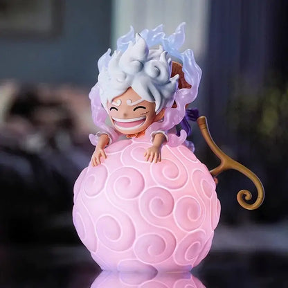 One piece devil fruit night light figure showing a cheerful white-haired figurine on a glowing pink light figure sphere