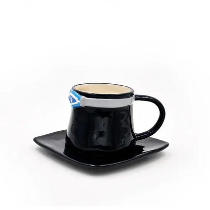 Black ceramic mug with silver and blue superman logo band on a matching black square saucer one piece luffy ace sabo set