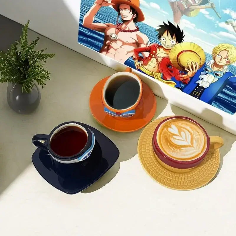 Three ceramic coffee cups with matching saucers in orange, navy, and reddish-brown featuring one piece luffy ace sabo mug set designs