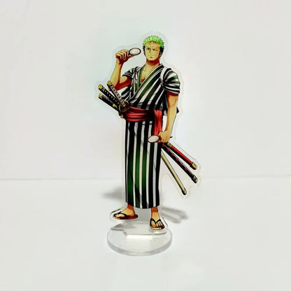 Clear acrylic stand featuring green-haired character in black and white striped robe with swords and magnifying glass