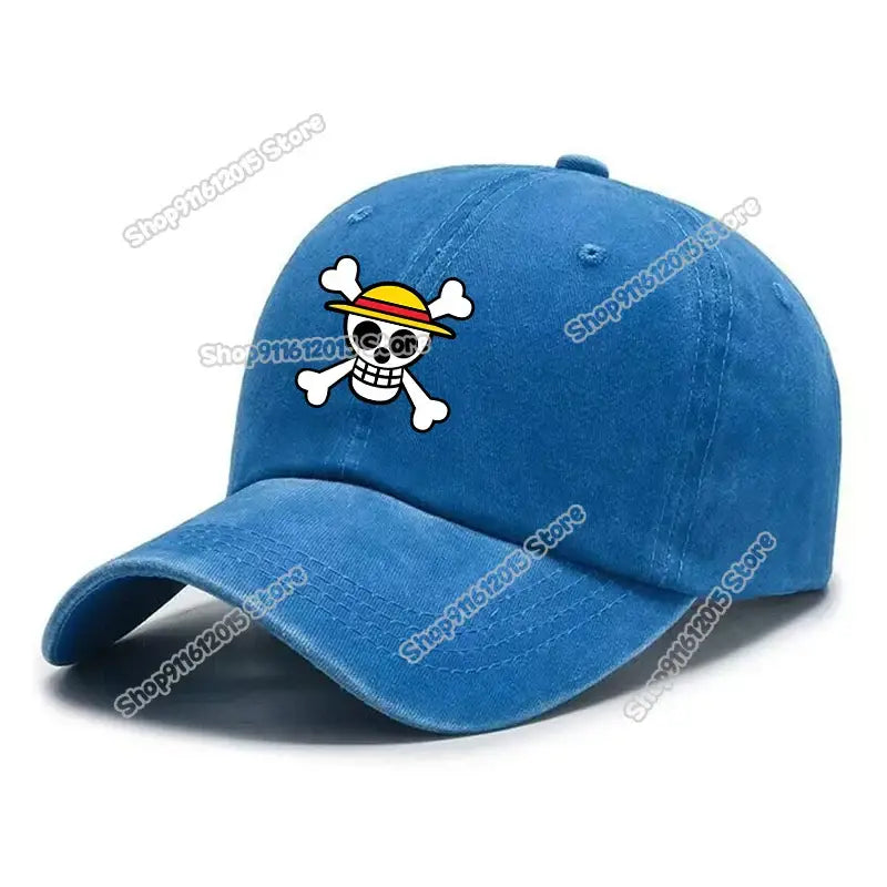 Blue denim washed retro baseball cap featuring a cartoon skull and crossbones emblem with a yellow straw hat