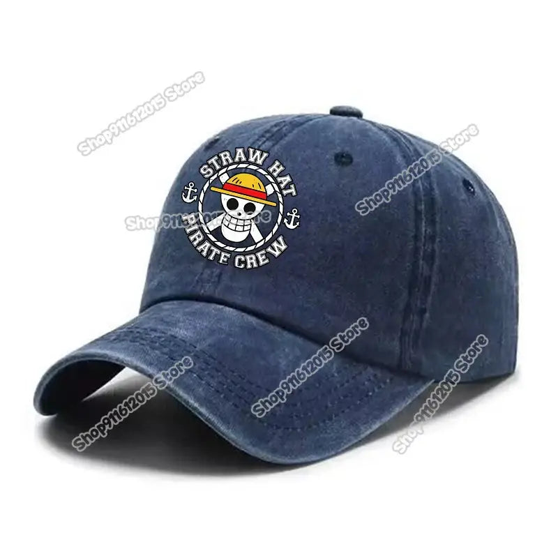 Navy blue denim baseball cap featuring a white embroidered straw hat pirate crew logo with anchor and skull design in washed retro style