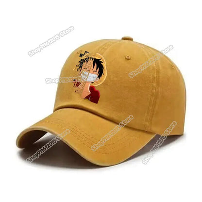 A mustard-yellow washed retro baseball cap featuring a printed luffy design from one piece with text elements
