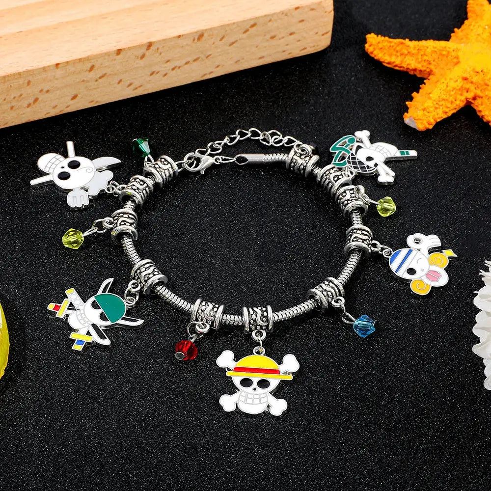 Silver diy charm bracelet featuring colorful enamel charms with central skull and crossbones wearing yellow hat for luffy fans