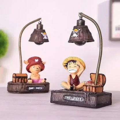 Dark brown resin led desk lamp with flexible gooseneck and skull emblem beside piece luffy chopper figurine