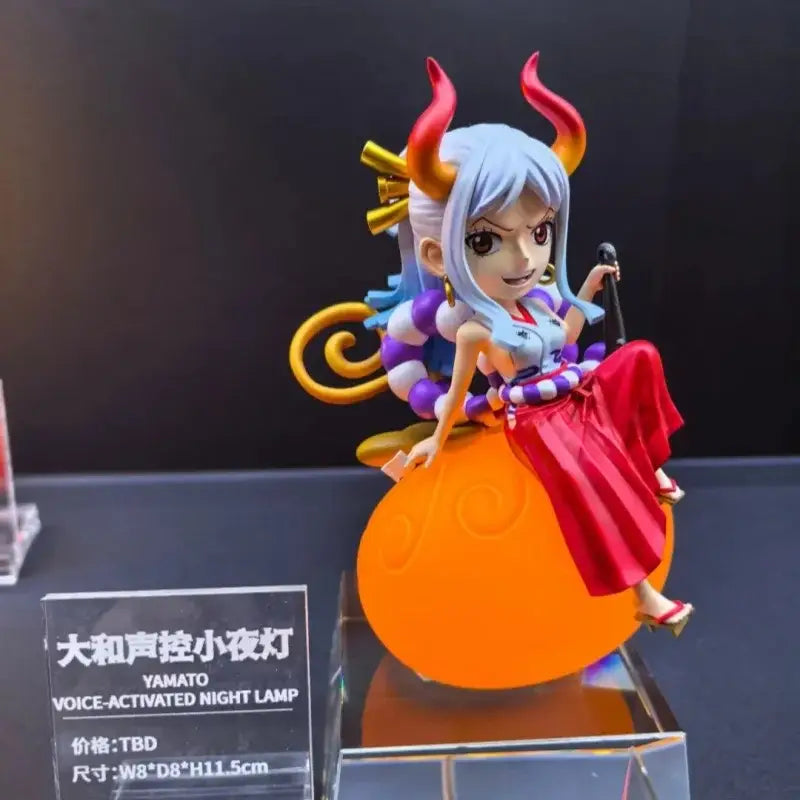 A vibrant orange piece devil fruit night light featuring a silver blue-haired anime figurine with red orange horns