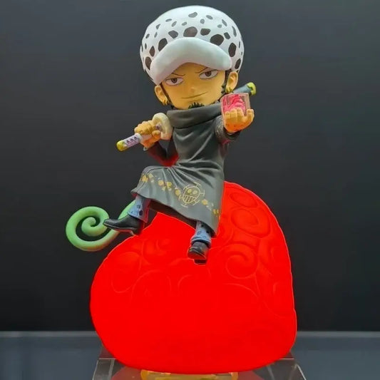 A detailed plastic figurine of a one piece devil fruit character with white hat, gold skull coat, on a red heart night light base