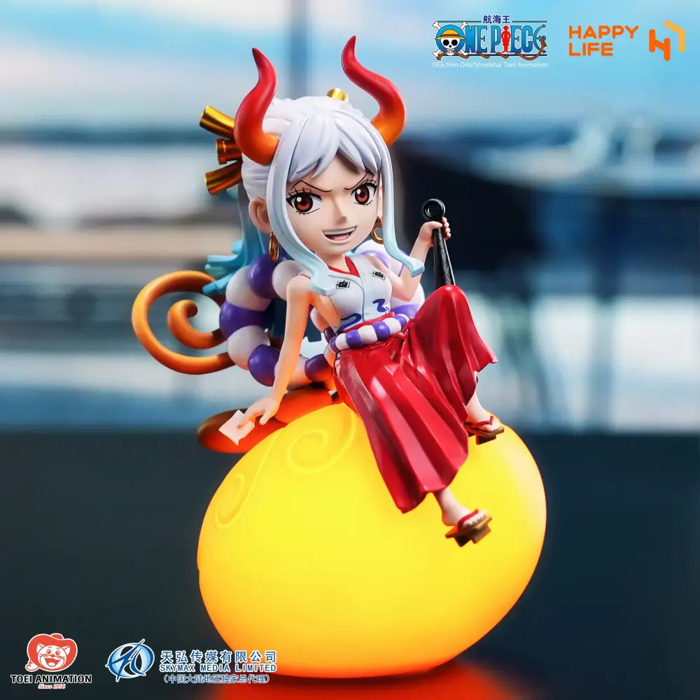 A vibrant yellow glowing devil fruit night light featuring a white hair figurine with red horns from one piece