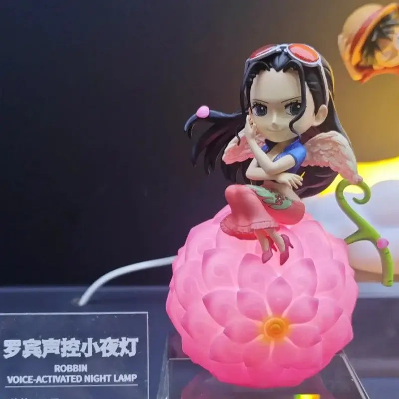 Pink translucent flower-shaped night light with chibi robbin figurine featuring black hair and pink wings devil fruit design
