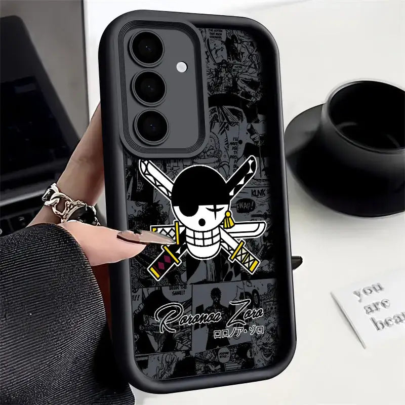 Black soft silicone piece luffy phone case featuring white and yellow one piece jolly roger on back with comic panels background