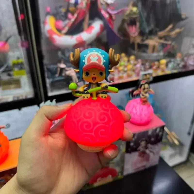 A glowing red spherical led lamp with a swirling pattern and chopper figurine from one piece on top