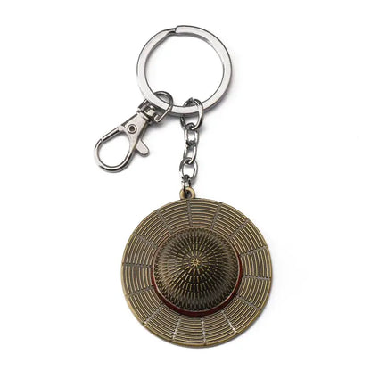 Bronze metal luffy hat keychain featuring a detailed circular hat design with concentric ridges and central starburst pattern