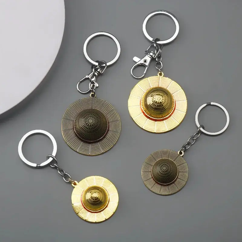 Metallic gold and bronze luffy hat keychain with detailed woven textures pendant keyring accessory