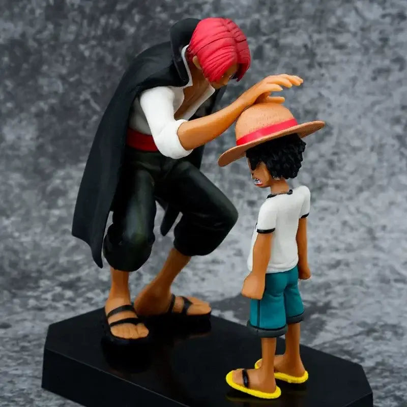 One piece monkey d luffy pvc statue 18cm showing a red-haired figure in black cloak kneeling beside a boy in straw hat